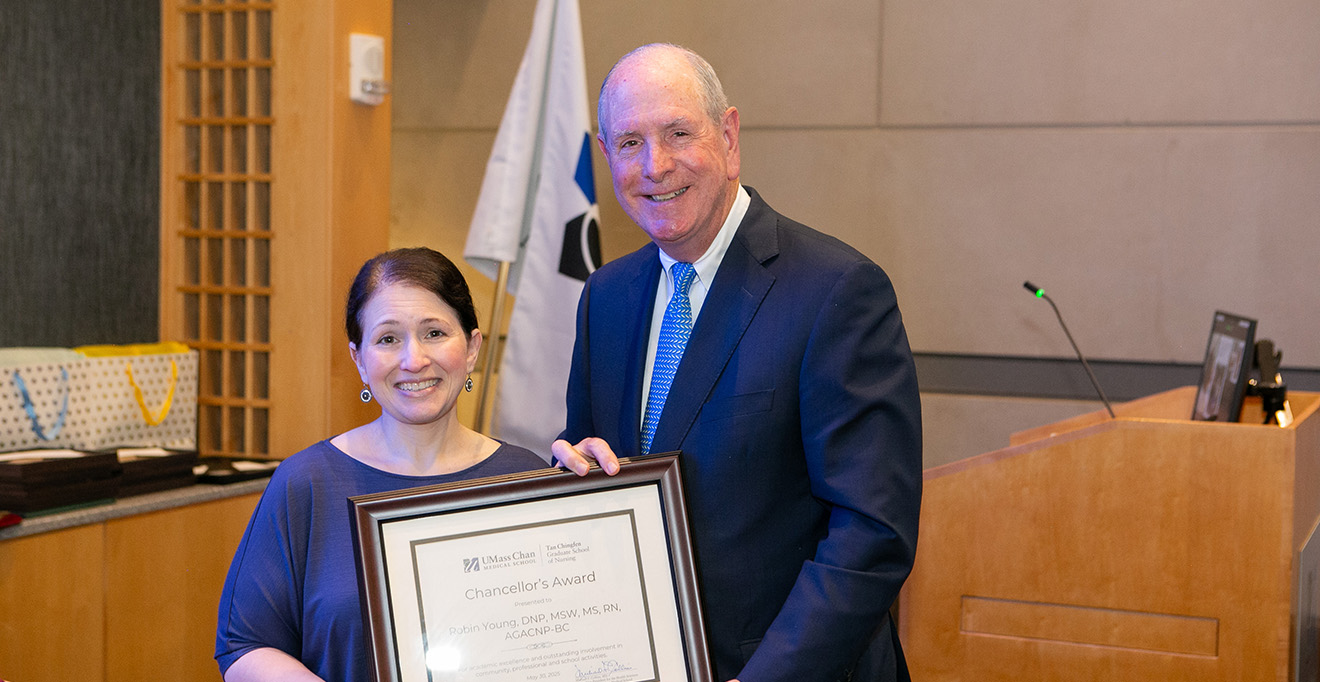 Photo of Chancellor Michael F. Collins presented the 2025 Chancellor’s Award to Robin Young, MSW, MS, RN, AGACNP-BC.