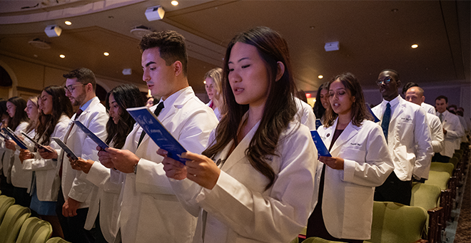 Newly cloaked medical students recite the Oath of Maimonides.