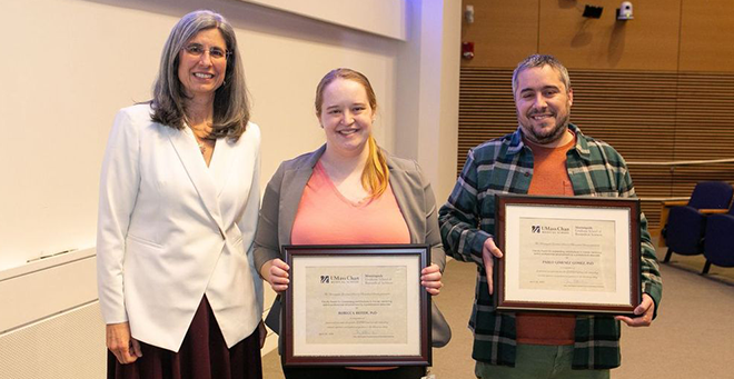 (L to R) Mary Ellen Lane, PhD, presents the Faculty Award for outstanding contributions to trainee mentoring and/or professional advancement by a postdoctoral associate to Rebecca Beiter, PhD, and Pablo Gimenez Gomez, PhD.