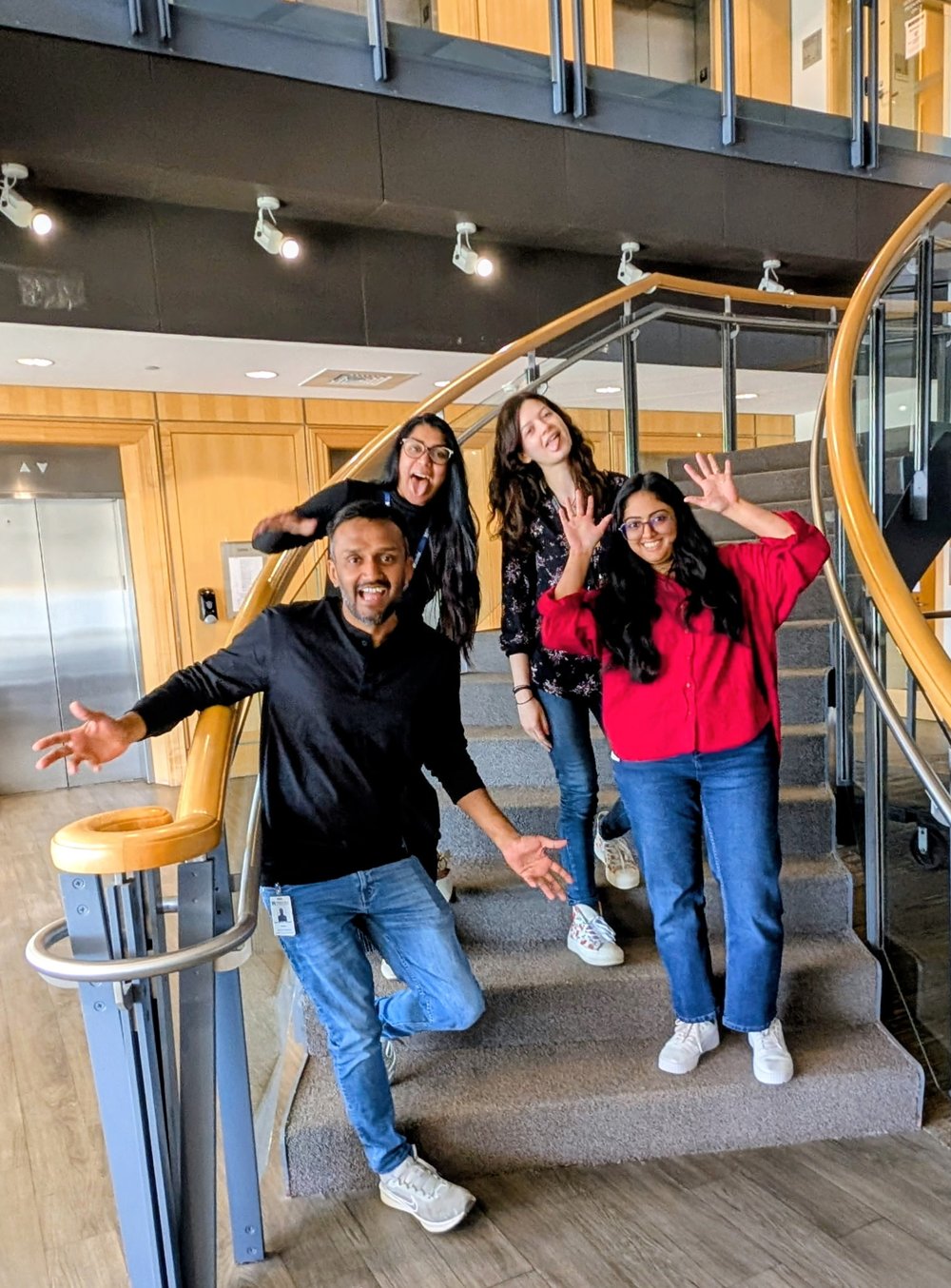 Varanasi Lab members celebrating on the stairs as they welcome Prasanthi Kaja to the lab